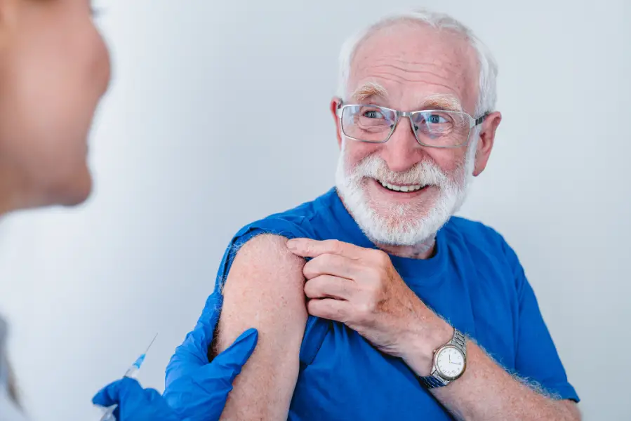 Elderly man receiving a vaccination